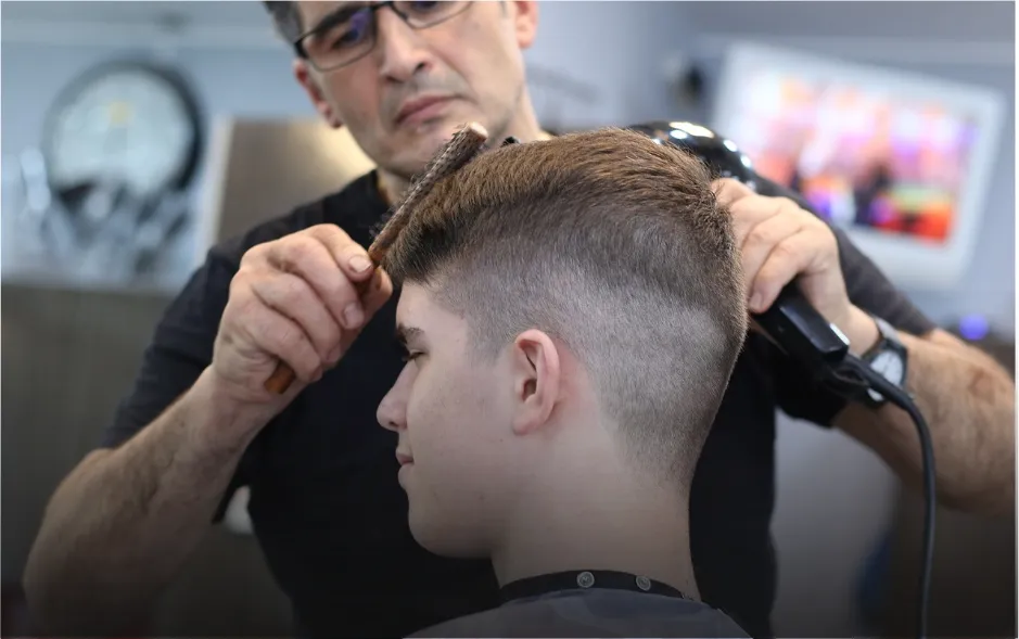 Un jeune homme se faisant coiffer
